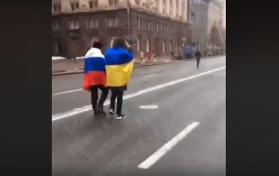 Центром Києва пройшли чоловіки з прапорами України і Росії
