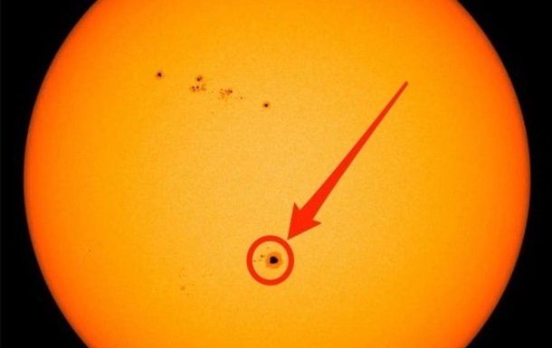 A sunspot appears on the sun as far as the eye can see